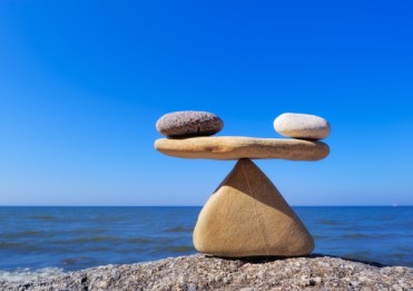 Symbol of scales is made of stones on the cliff